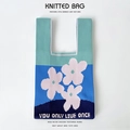Detail of blue knitted tote bag with floral patterns and You Only Live Once text - Blue Three Flowers