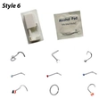 Nose piercing kit detail with 8 silver studs, a star shape, and alcohol prep pad - Piercing Gun + 9 Studs