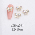 Macro detail of 3D alloy butterfly nail charms with iridescent crystals and golden frame - Aurora White Butterfly with Gold Base (A761)