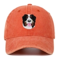 Close-up of Bernese Mountain Dog embroidery on an orange washed canvas baseball cap - Orange
