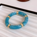 Detailed close-up of blue marble resin beads and polished gold metal balls on a vintage cuff - Blue Marble Pattern Round Metal Spliced Bracelet (No. 21 Bracelet - Blue - Round)