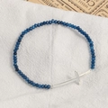 Natural blue stone beaded bracelet with silver horizontal cross on white linen cloth - Silver Plated Blue