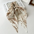 Beige marble pattern chiffon scrunchie with long ribbon tie on artistic book background - Tie-dye Coffee Ribbon