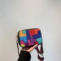 Colorful geometric patchwork crossbody bag with wide ethnic style woven shoulder strap - Black