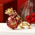 Red enamel money bag keychain with gold finish and rhinestone accents for bag charm - Red Fortune Bag