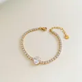 Golden stainless steel bracelet featuring round zircon chain and oval centerpiece stone - Stainless Steel/Zirconia / Gold Oval Main Stone Style (SBK373)