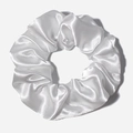 Close-up of white satin scrunchie with smooth silk texture and soft pleat details - White