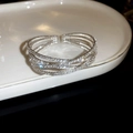 Close-up of silver-tone crisscross bangle with sparkling rhinestones and pearls - 4# 4-Layer Silver Cross Bangle