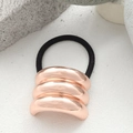 Minimalist rose gold metallic oval hair tie with three-layer pleated design and black cord - Triple Layer Arc Rose Gold