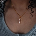 Elegant gold titanium steel necklace featuring a vertical triple zircon pendant detail - Gold White