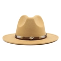 Macro detail of camel wool felt fedora with braided band and golden shell ornament - Camel
