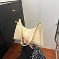 Chic beige crocodile pattern baguette shoulder bag held by model for sizing reference - Beige