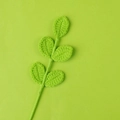 Close-up of green hand-crocheted yarn leaves with detailed knitted texture for floral decor - 5 Leaves / Bud Green