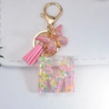Pink glitter resin letter M keychain with butterfly charms and soft suede tassel - Letter M