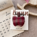 Close-up of handmade fabric plaid apple hair clip on a bunny branded display card - Plaid Apple Hair Clip