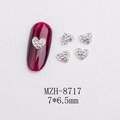 Detailed view of silver heart nail art rhinestones with dimensions and application on red nail - Silver Heart White Rhinestone Style(8717)