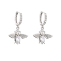 Detailed view of silver bee earrings with micro-pave crystals and pearl accent - White Gold Bee