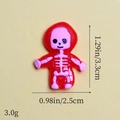 Macro view of pink skull resin charm with dimensions 1.29 x 0.98 inches and 3g weight - Red Skull Doll