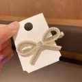 Elegant champagne gold bow hair clip with white pearls and sparkling rhinestones - Bowtie