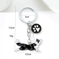 Creative black and white Border Collie metal keychain charm with paw print pendant - Running Border Collie (Running Shepherd Paw)