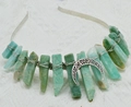 Macro view of natural green fluorite stones and moon pendant on crown headband - Amazonite
