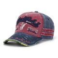 Macro view of distressed red and blue baseball cap with Black Rebel embroidery details - Red Stitching Blue (F)