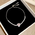 Macro view of adjustable pink heart-shaped crystal bracelet with slider clasp in a box - Silver-Pink