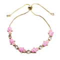 Detail of gold adjustable pull-string bracelet with pink Hamsa hand and evil eye charms - Pink