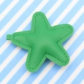 Green star-shaped PU leather keychain pendant with detailed stitching on striped background - Green