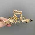 Elegant gold wavy metal hair claw clip held by hand for a minimalist aesthetic look - Minimalist Geometric Wave Style / Medium / Gold