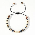 Close-up of bohemian beaded bracelet with natural blue stones and golden metal spacers - Blue Beige Brown Mixed Beads-Black Cord-Single Bracelet