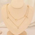 Detail of layered gold heart necklace with square zircon charms on a beige bust display - Multi Heart Square Gem Style (12#)