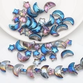 Macro shot of iridescent moon and star glass beads for DIY jewelry making kits - Half Blue Multicolor Inside