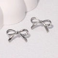 Minimalist polished silver bow knot stud earrings on a clean white textured background - Steel