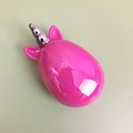 Close-up of pink unicorn hairbrush with silver horn on a minimalist beige background - Iridescent Rose Red