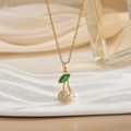 Close-up of cherry pendant with micro-pave crystals and pearl on gold chain - Gold Pearl Pave Zirconia Cherry