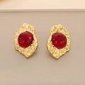 Macro shot of gold-plated vintage earrings with red cat-eye stone and hammered texture - Gold Red Style (KE116413-KFC)