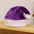 Soft plush purple Christmas hat with white faux fur trim and pompom on wooden surface - Purple