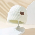 Winter ribbed knit beanie in white featuring a brown leather W patch on a hat stand - One Size / White