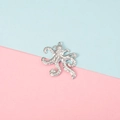 Macro shot of a silver metal octopus pendant with detailed tentacles on a pastel background - Detailed Octopus Shape Style (3#)