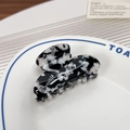 Small acetate hair claw clip with black and white marble pattern in ceramic dish - Rhinestone Black