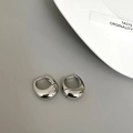 Macro shot of silver teardrop hoop earrings with polished metallic mirror finish - Chunky Waterdrop Hoop / Silver