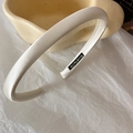 Detail of cream white satin padded headband with smooth fabric texture and handmade label - Milk White