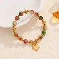 Colorful gemstone beaded stretch bracelet with a polished gold heart charm on beige background - Multicolor Beads-Gold Smooth Heart Charm