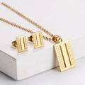 Detailed view of golden rectangle necklace and earrings set with Greek fret pattern - Square Meander