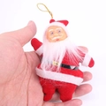 Close-up of a small plush Santa Claus ornament held in hand to show size and texture - 19cm / Red