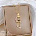 Detail of moon tassel necklace with crystal pavé and black stone in a jewelry box - Gold Moon Projection Style (D209)