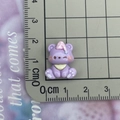 Purple resin bear figurine with pink hat on scale showing 2cm size for DIY crafts - Purple Winking Bear