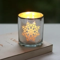 Silver plated glass candle holder with snowflake cutout pattern and warm glowing candle - Silver Large Snowflake