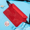 Waterproof red PVC waist bag with triple-seal closure and adjustable strap on water - Red